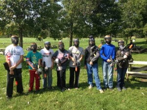 Low impact paintball birthday party. Kids smiling with markers and masks.