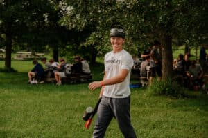 Kid with paintball market sticking his tongue out